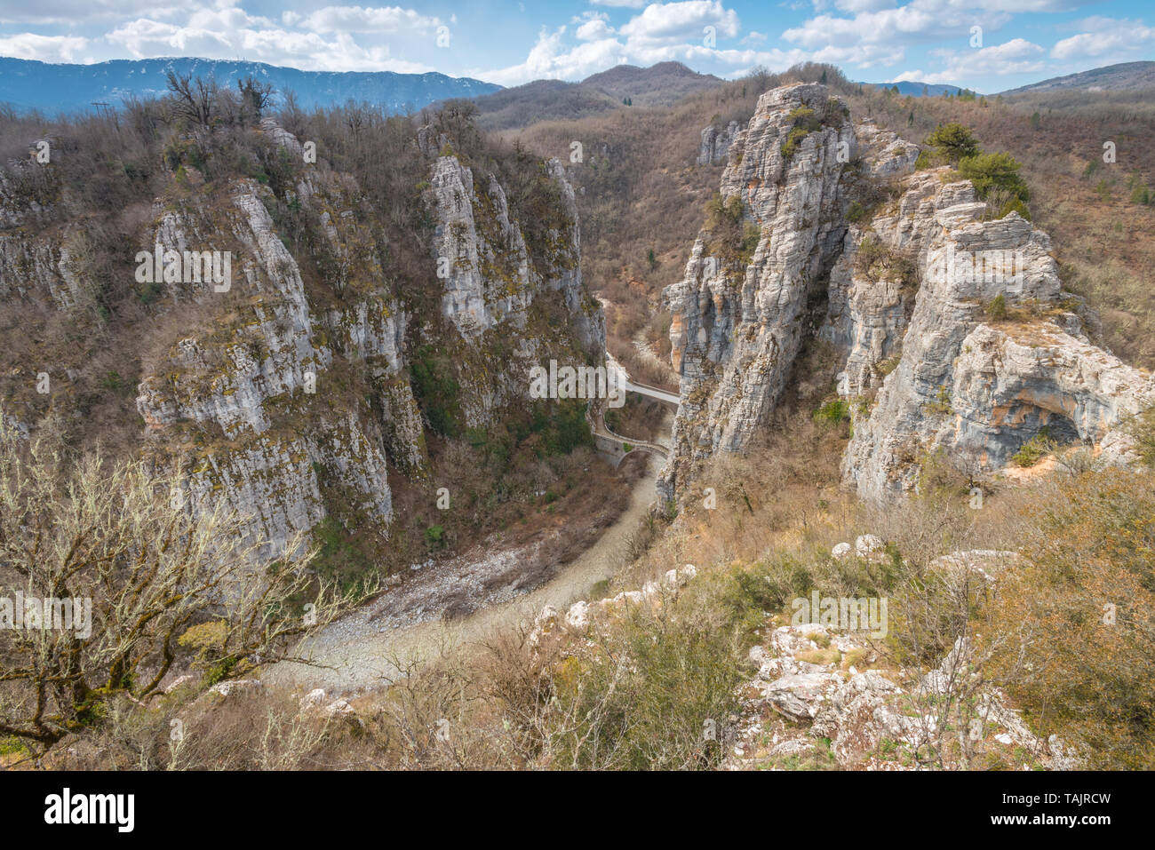 Views of the mountainous country in Zagoria, with canyon views, dry riverbed and old stone bridge of Kokkori or Kokkoros. Stock Photo