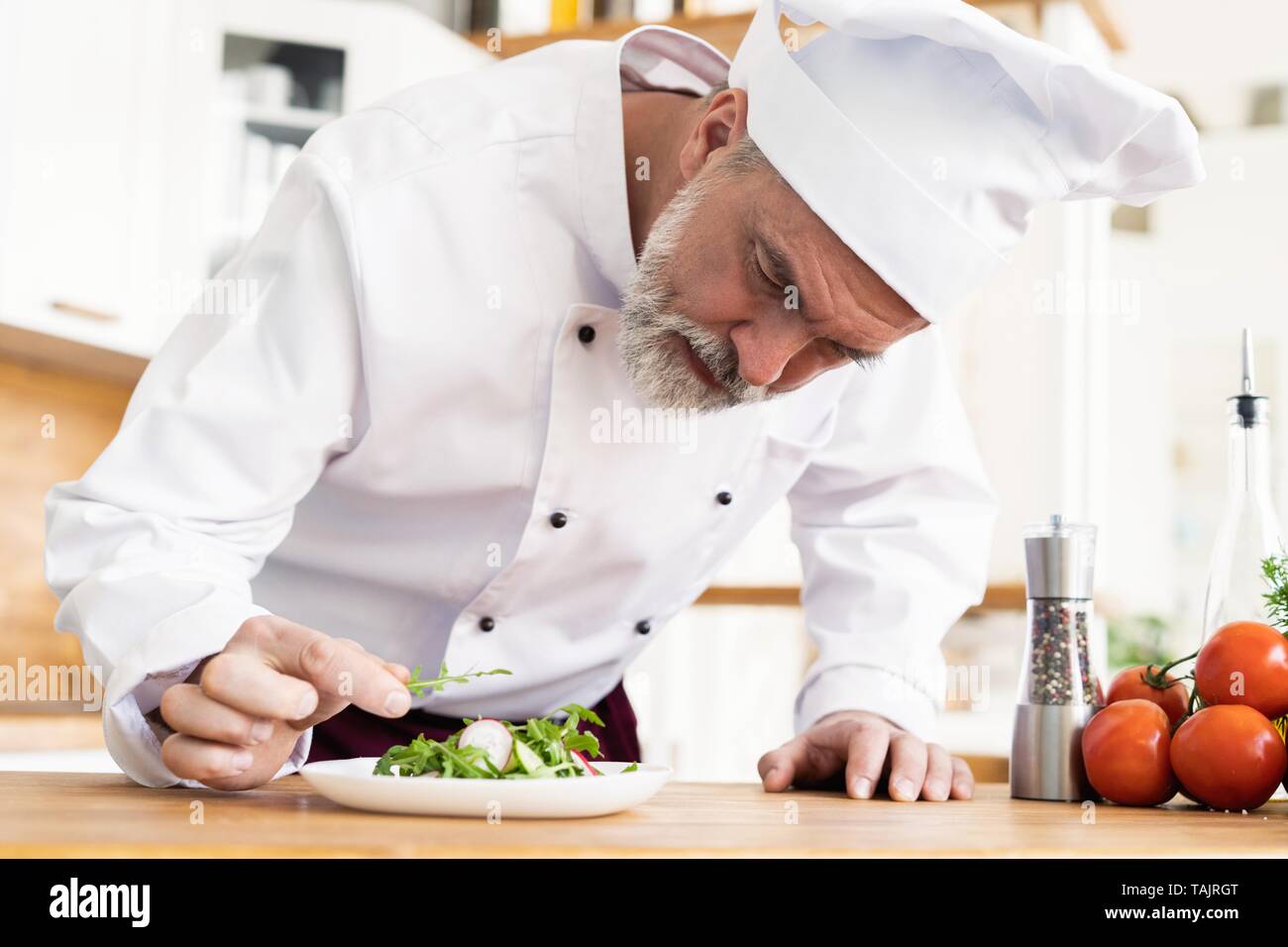 Male Cook Chef Decorating Garnishing Prepared Salad Dish On The