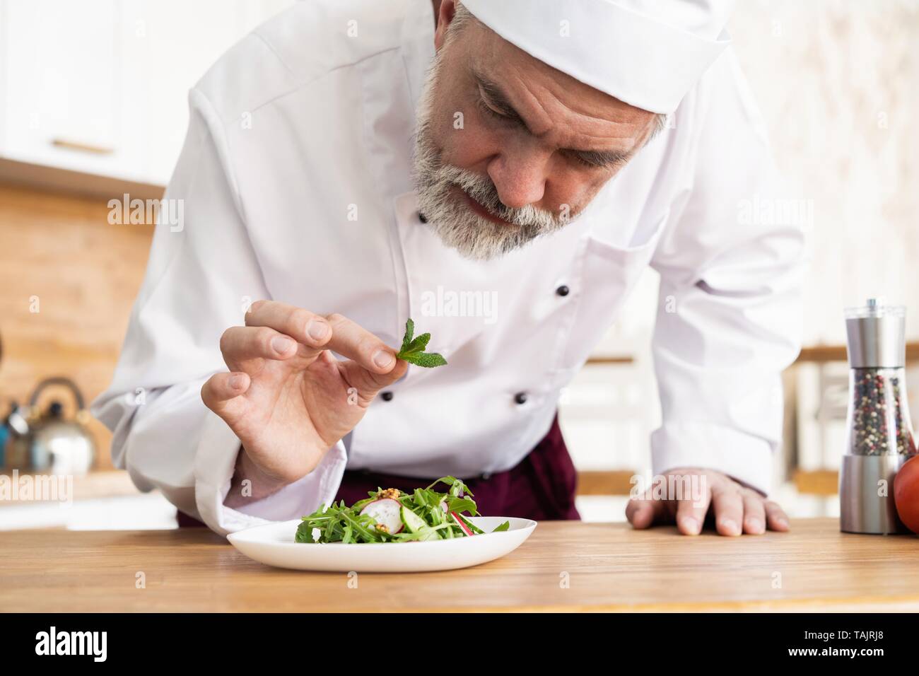 Male Cook Chef Decorating Garnishing Prepared Salad Dish On The