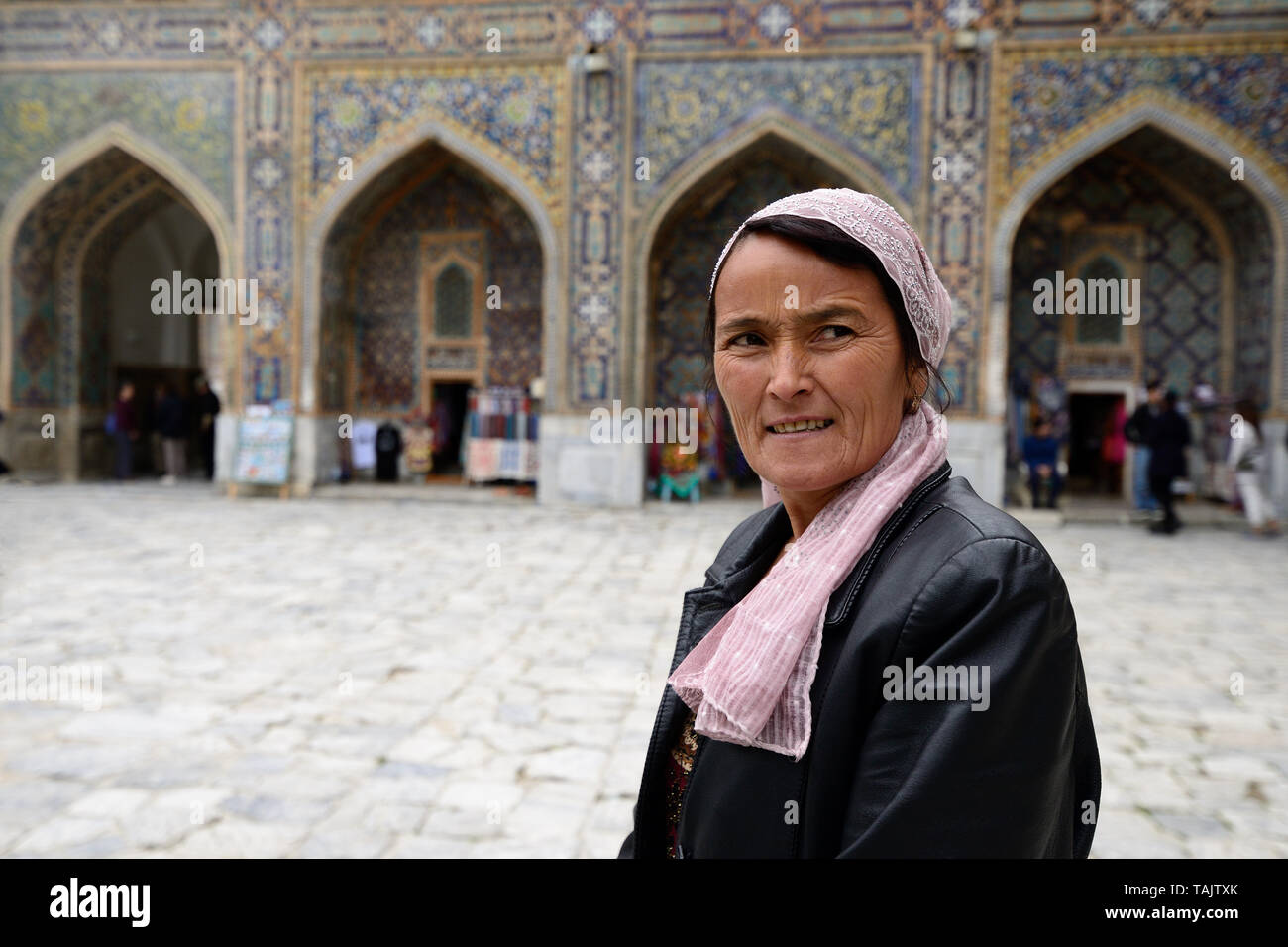 SAMARKAND, UZBEKISTAN - 22 APRIL 2019: The Uzbek tourist with the admiration is examining monuments of Samarkand on the Silk Route, Registon main squa Stock Photo