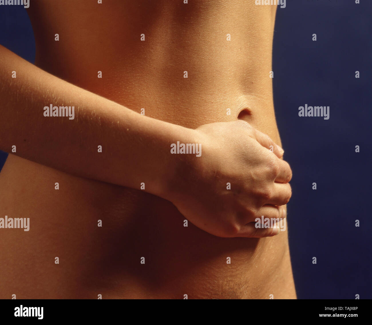 Woman with stomach ache feeling tummy, Winkfield, Berkshire, England, United Kingdom Stock Photo