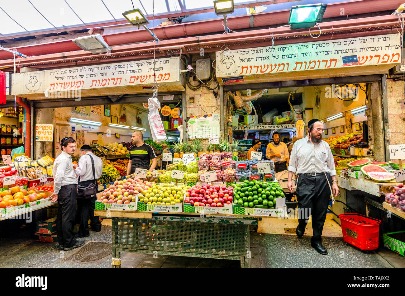 Jerusalem, Israel- August 16, 2016: A crowd of men shopping for vegetables in a shop in the Mahane Yehudah market in Jerusalem, Israel Stock Photo