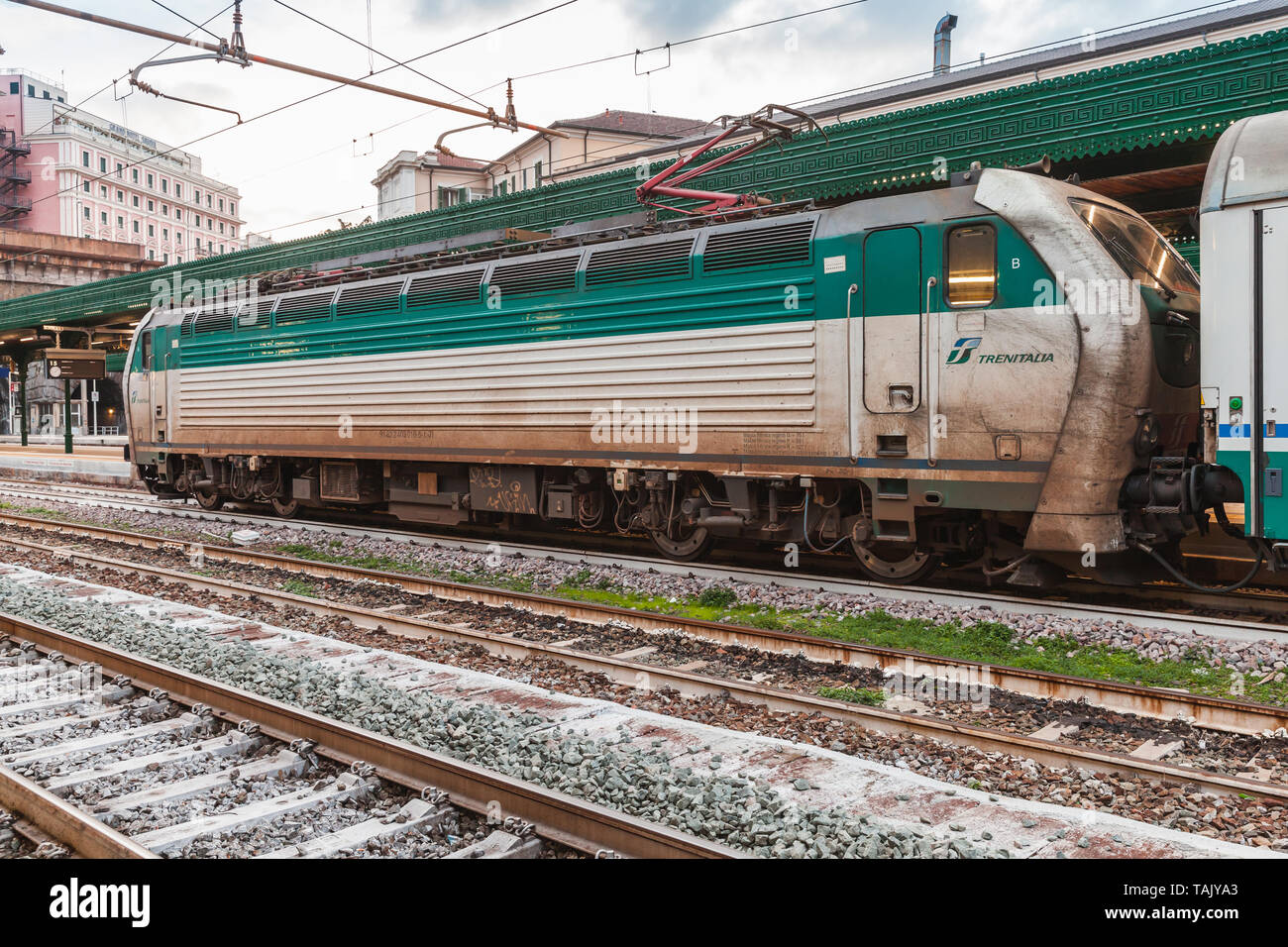 Genova, Italy - January 19, 2018: White green locomotive by Trenitalia which is the primary train operator in Italy Stock Photo