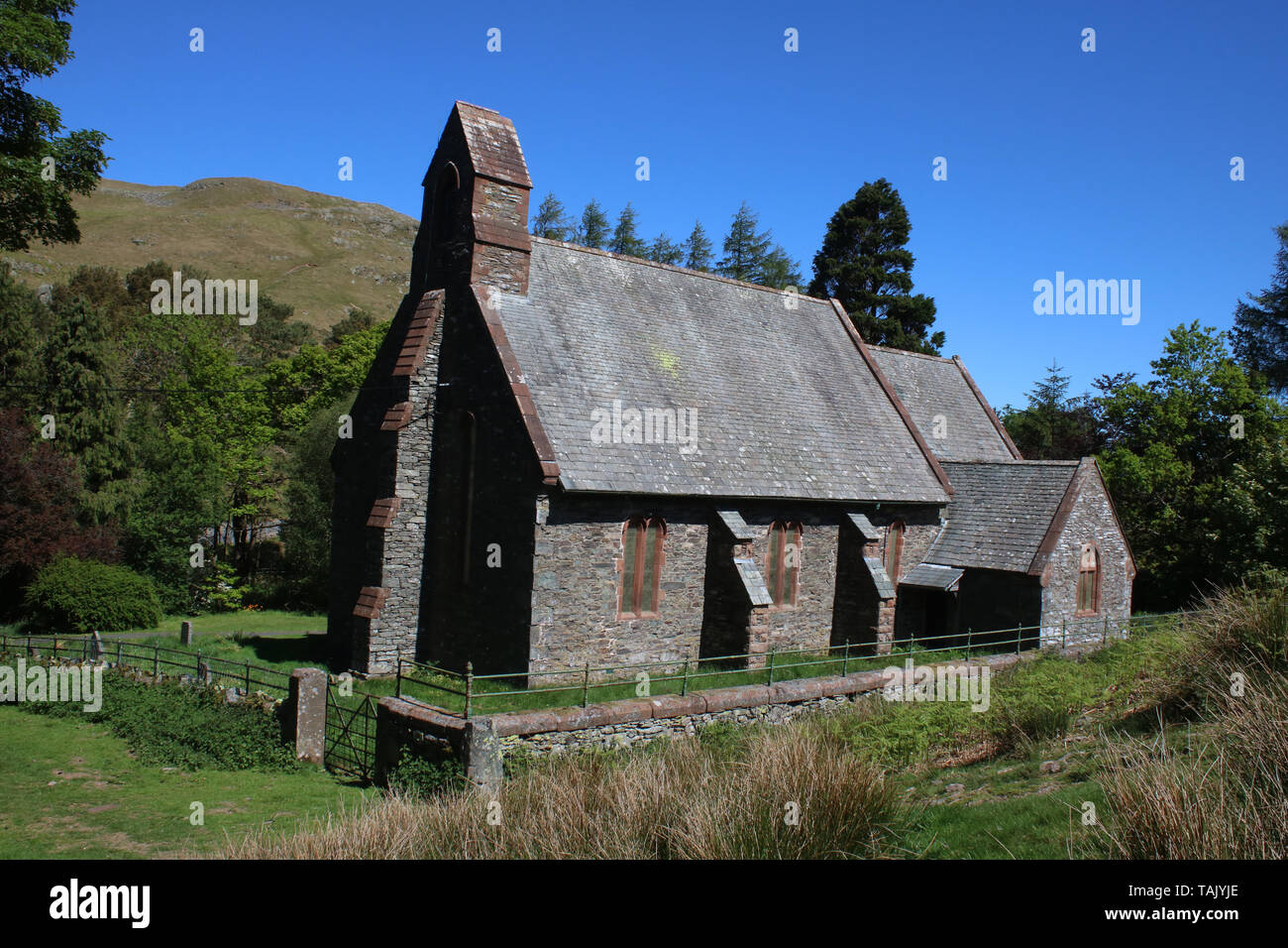 Parish Church of Saint Peter in Martindale in the English Lake District, Cumbria, United Kingdom with Hallin Fell in the background. Stock Photo