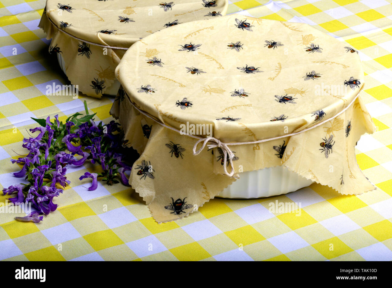 Homemade Yellow Beeswax Container Wraps with Cute Bee Design on a