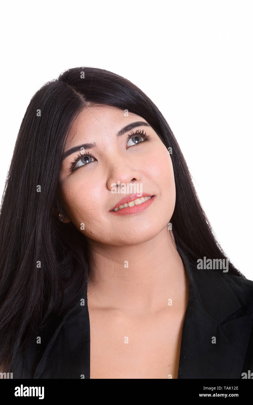Studio Portrait Of Young Happy Asian Woman Thinking Stock Photo - Alamy