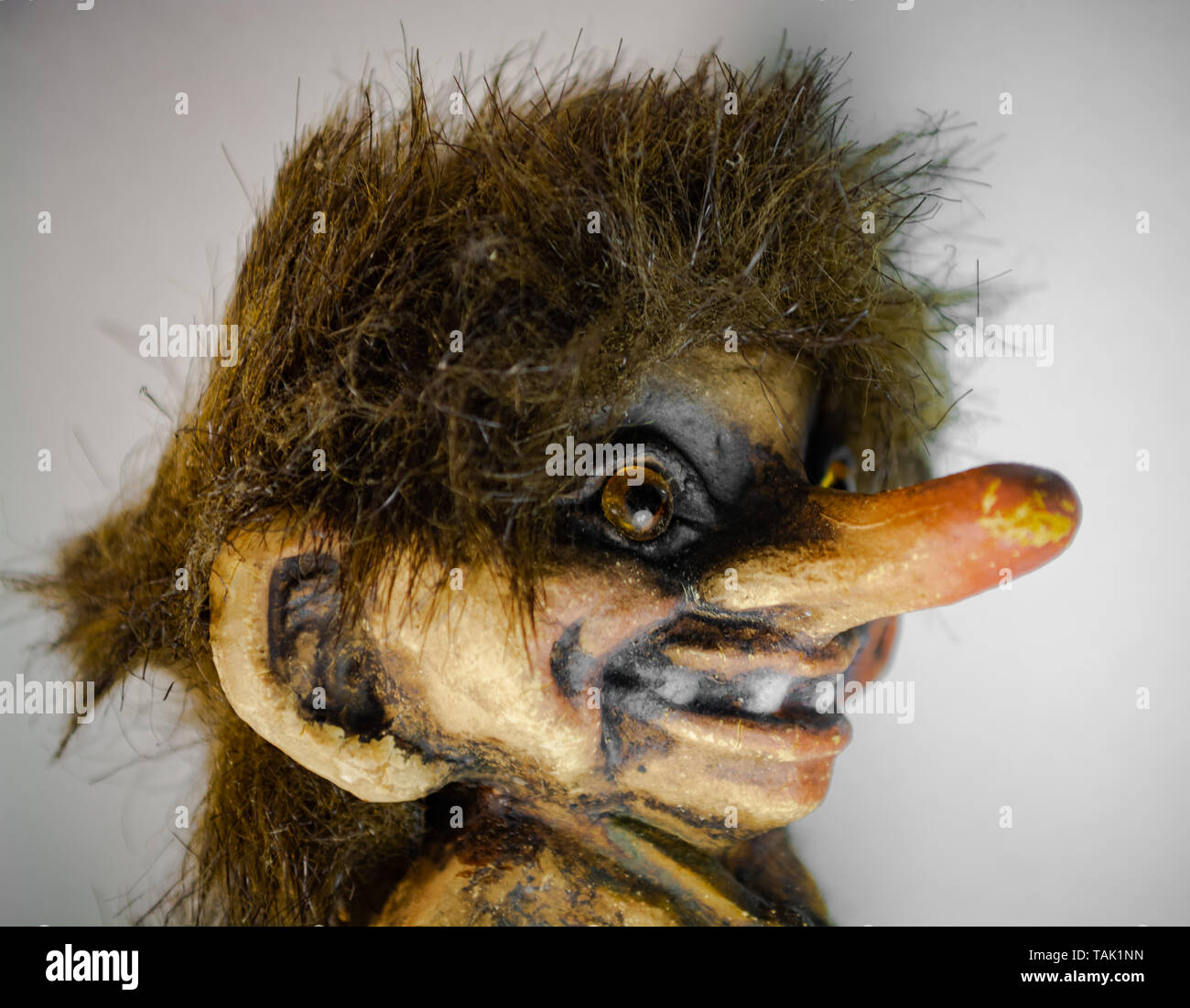 Young Scandinavian troll figure with grin Stock Photo