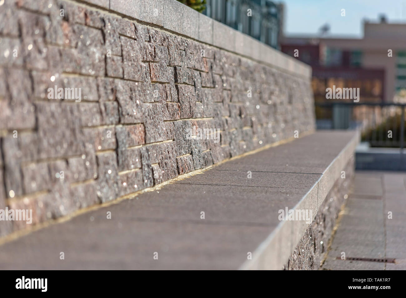 Built In Stone Bench With Buildings And Sky In The Blurry