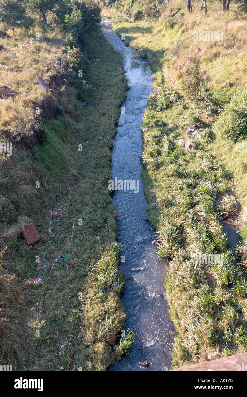 A close up arieal view of a river flowing under the railway bridge Stock Photo