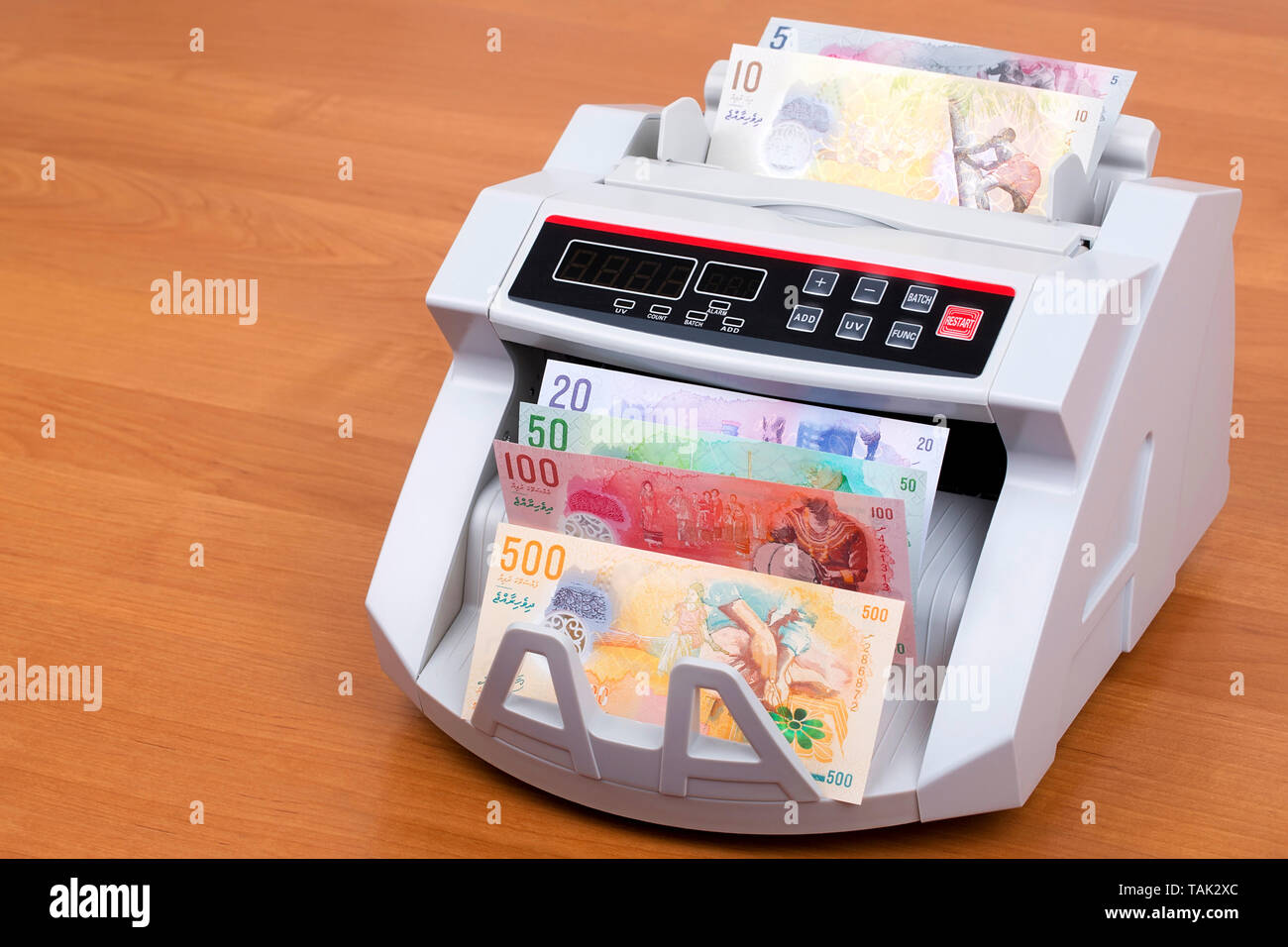 Maldivian Rufiyaa in a counting machine Stock Photo