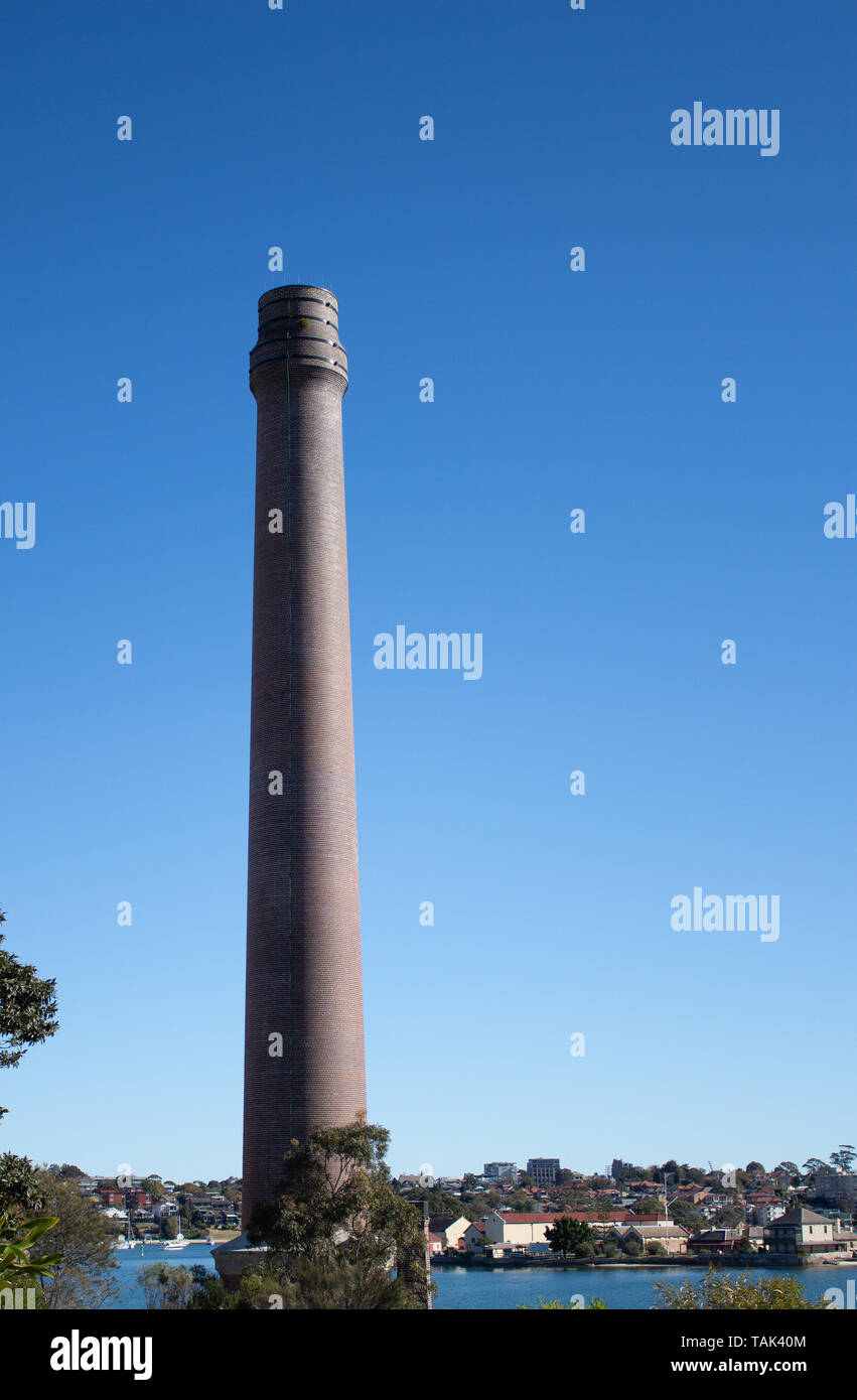 Factory brick smoke stack against blue sky set on Cockatoo Island Sydney Harbour Australia Stock Photo