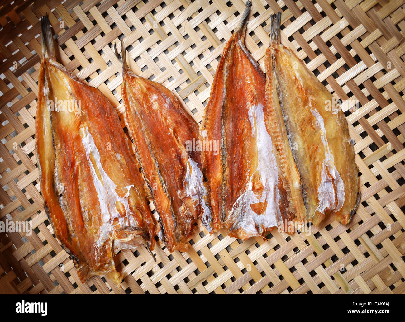 Making dried fish / dry salted fish on threshing basket background Stock Photo