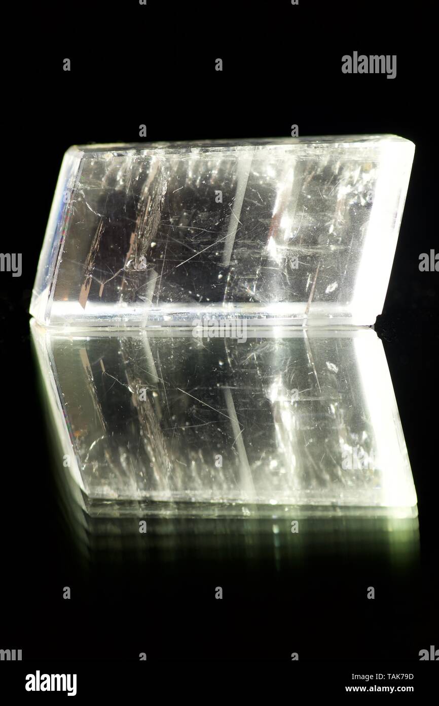 Icelandic Spar Calcite Crystal on a Shiny Black Background. Macro