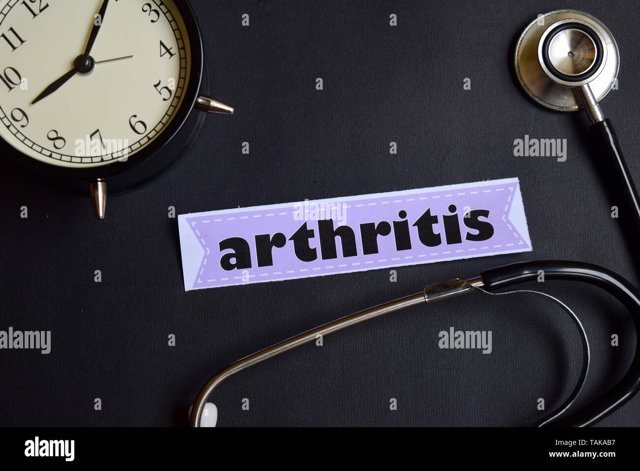 arthritis on the paper with Healthcare Concept Inspiration. alarm clock