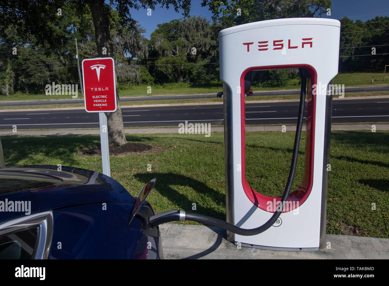 A Tesla 3 Electric Car Charges At A Tesla Charging Station Stock Photo