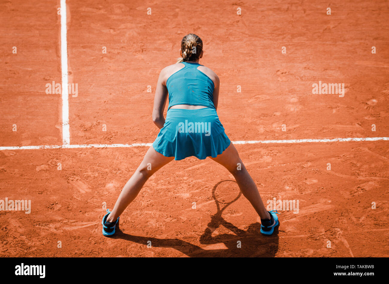 Back view  of a woman playing tennis, waiting to receive service,  outdoor competition game, running, professional Stock Photo