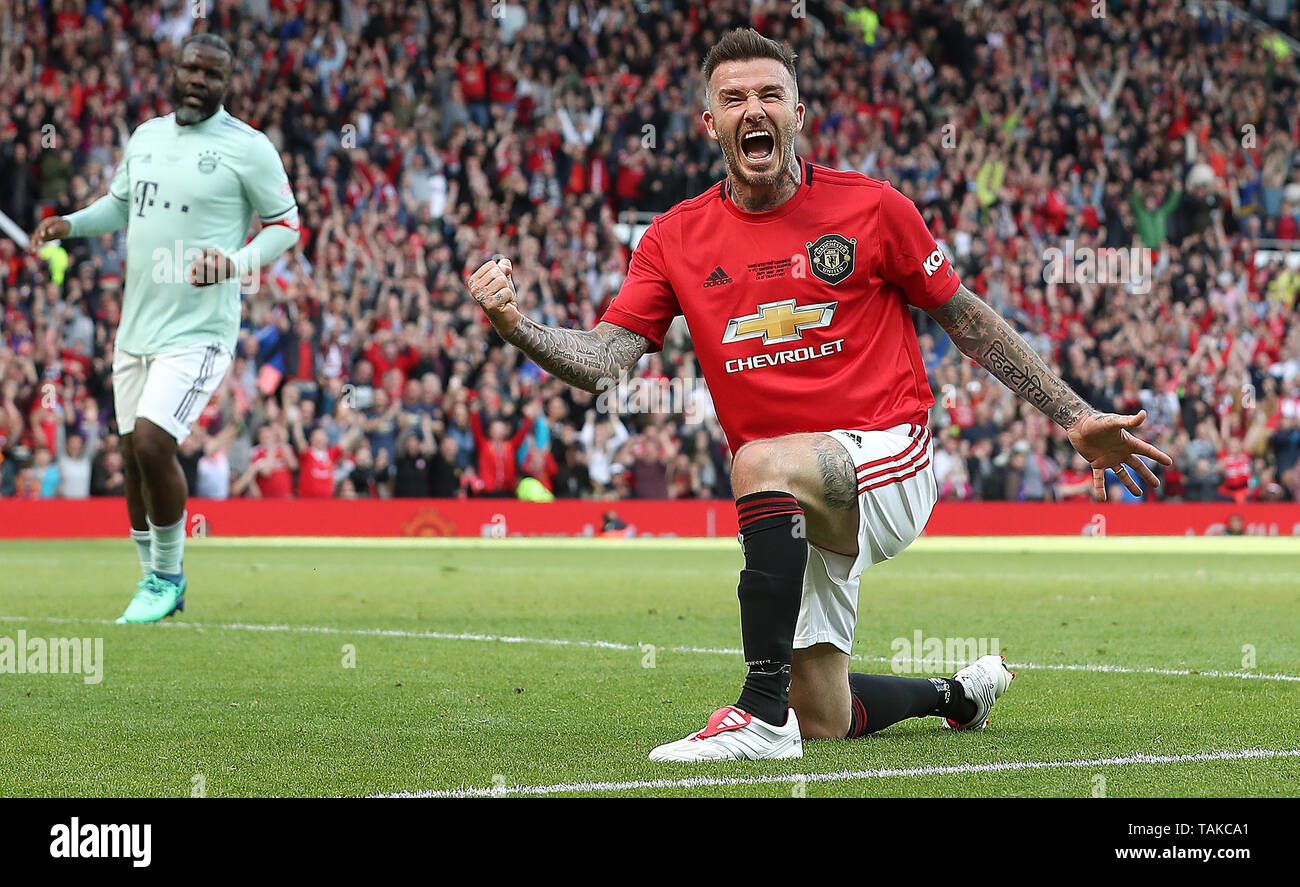 Manchester United Legends player David Beckham celebrates his goal during the legends match at Old Trafford, Manchester. Stock Photo