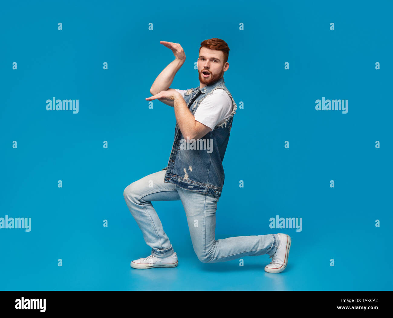 Funny millennial guy dancing in egypt style Stock Photo