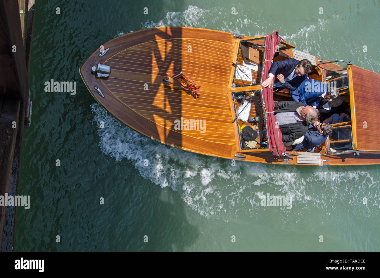 VENICE, ITALY - MAY 20, 2019: Overhead view of the Mayor of Venice - Luigi Brugnaro (sitting top right) travelling with his aids iin his official boat Stock Photo