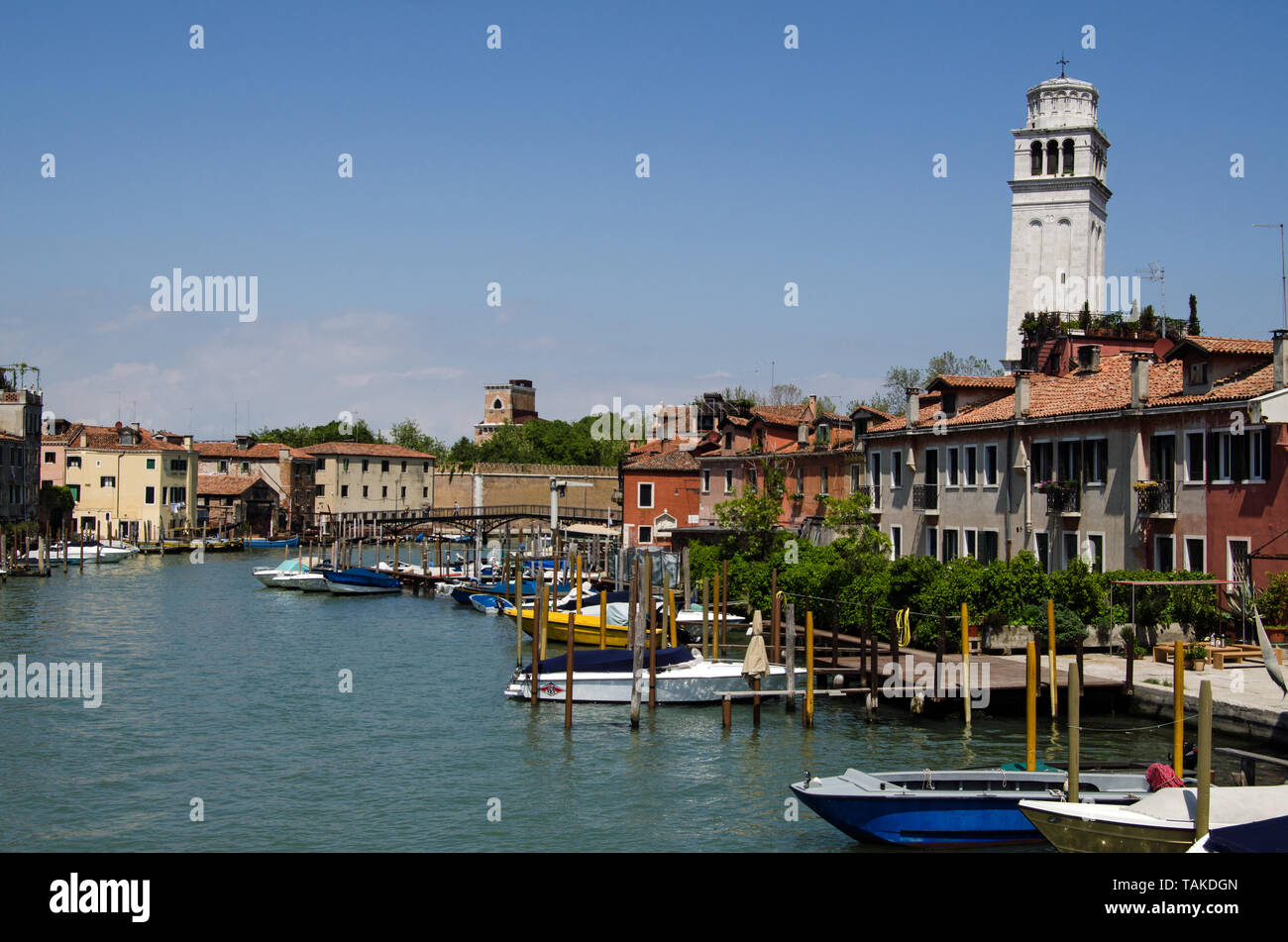 VENICE, ITALY - MAY 10, 2019:  View on a sunny day along the Canale di San Pietro in Venice.  To the right is the bell tower of the Basilica di San Pi Stock Photo