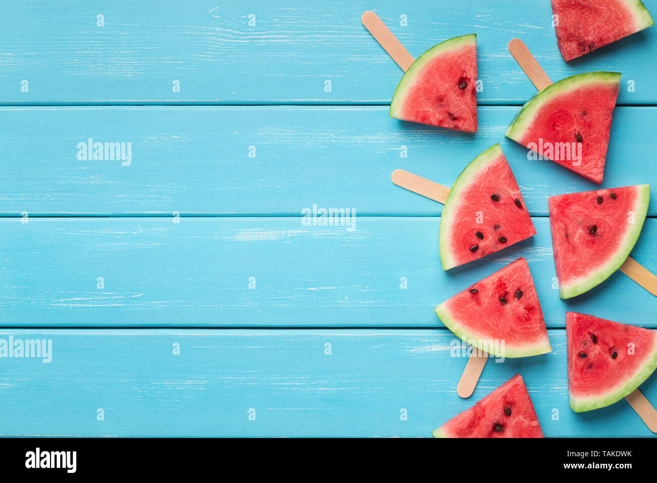 Watermelon triangles on wooden sticks, blue wood background Stock Photo ...