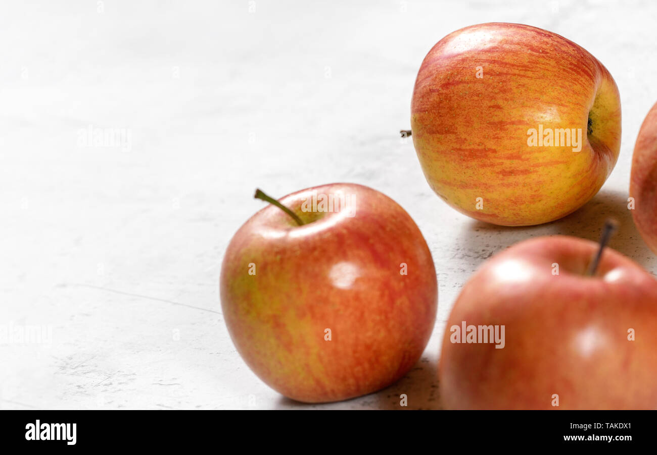Bright red and yellow apples fuji kiku variety on white board