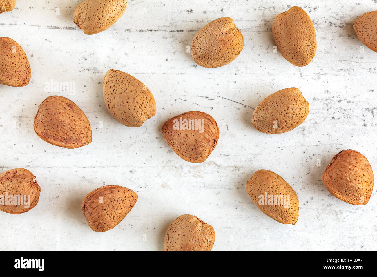 Top down view, whole almonds in shell on stone board Stock Photo