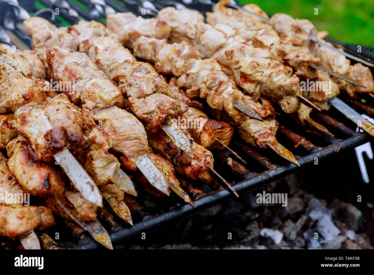 Grilling marinated shashlik on a grill. Shashlik is a form of Shish kebab  popular in Eastern, Central Europe and other places. Shashlyk meaning skewer  Stock Photo - Alamy