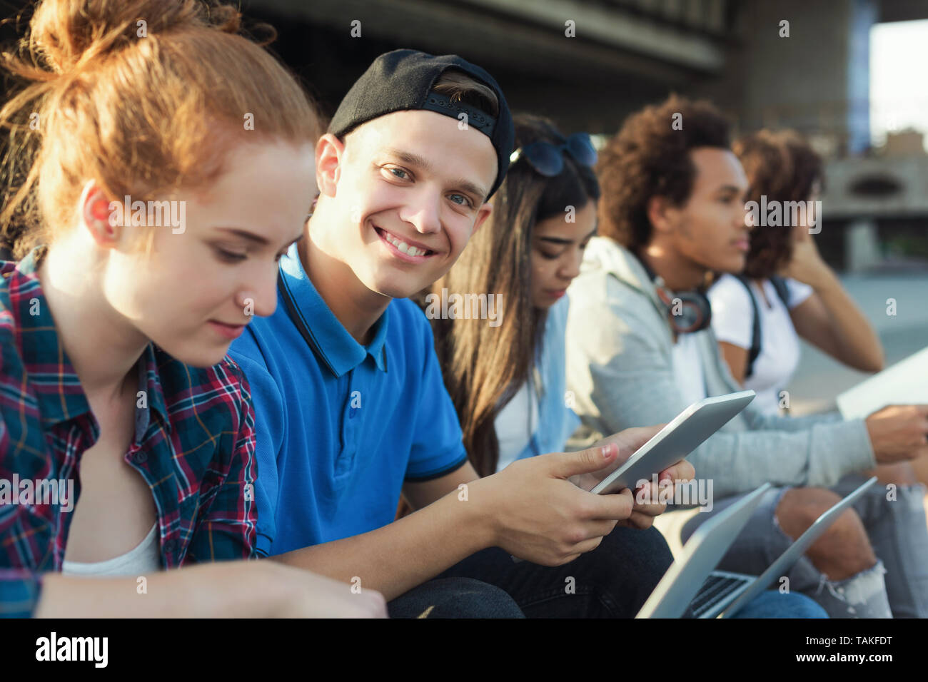College students studying outdoor, preparing for exams Stock Photo
