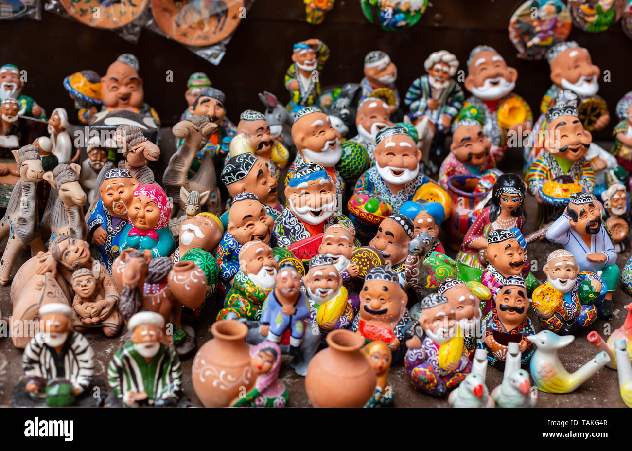 the showcase with Uzbek Souvenirs, ceramic figurines of people. Stock Photo
