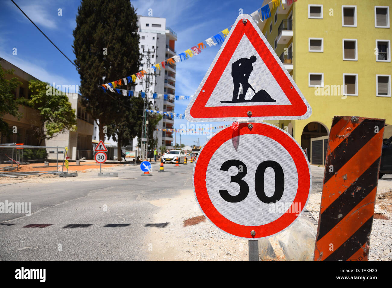 Roadwork and speed limit traffic signs in Yehud - small city in central Israel. Stock Photo