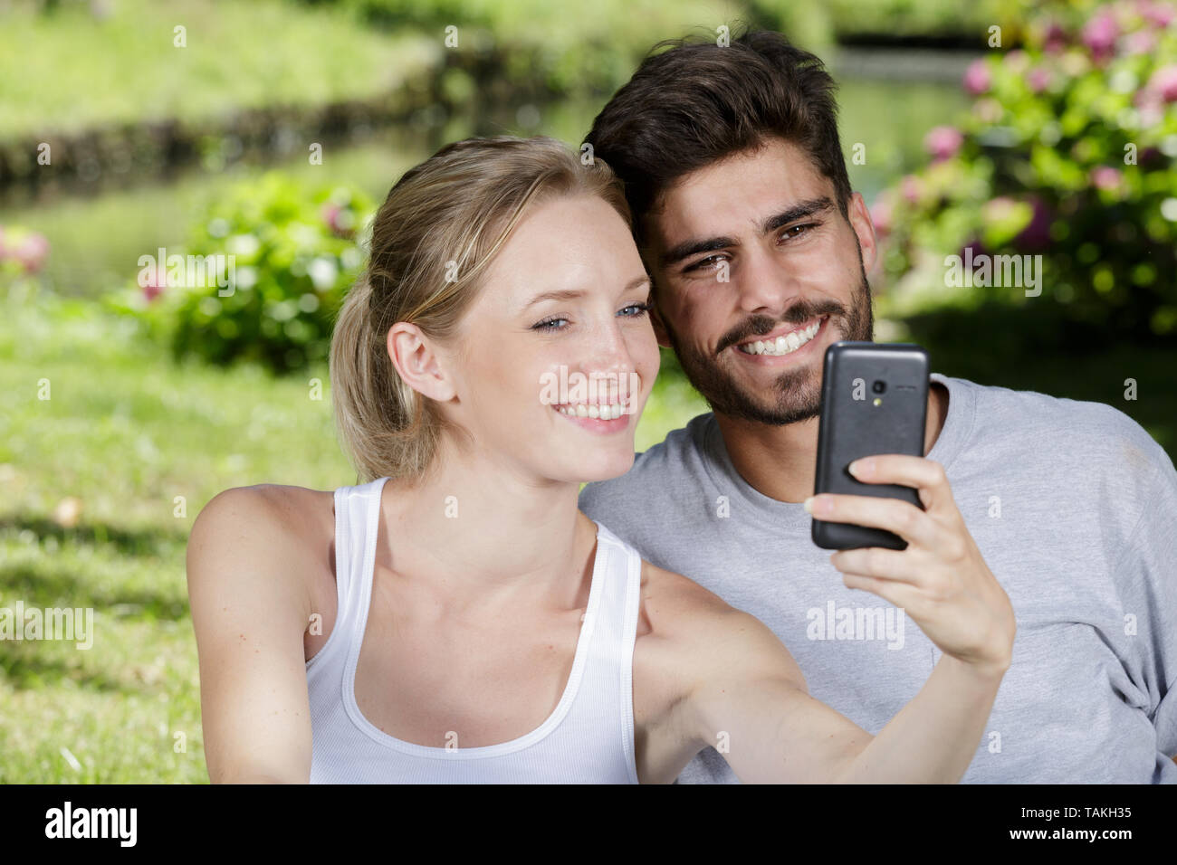 young couple taking selfie at the park Stock Photo - Alamy