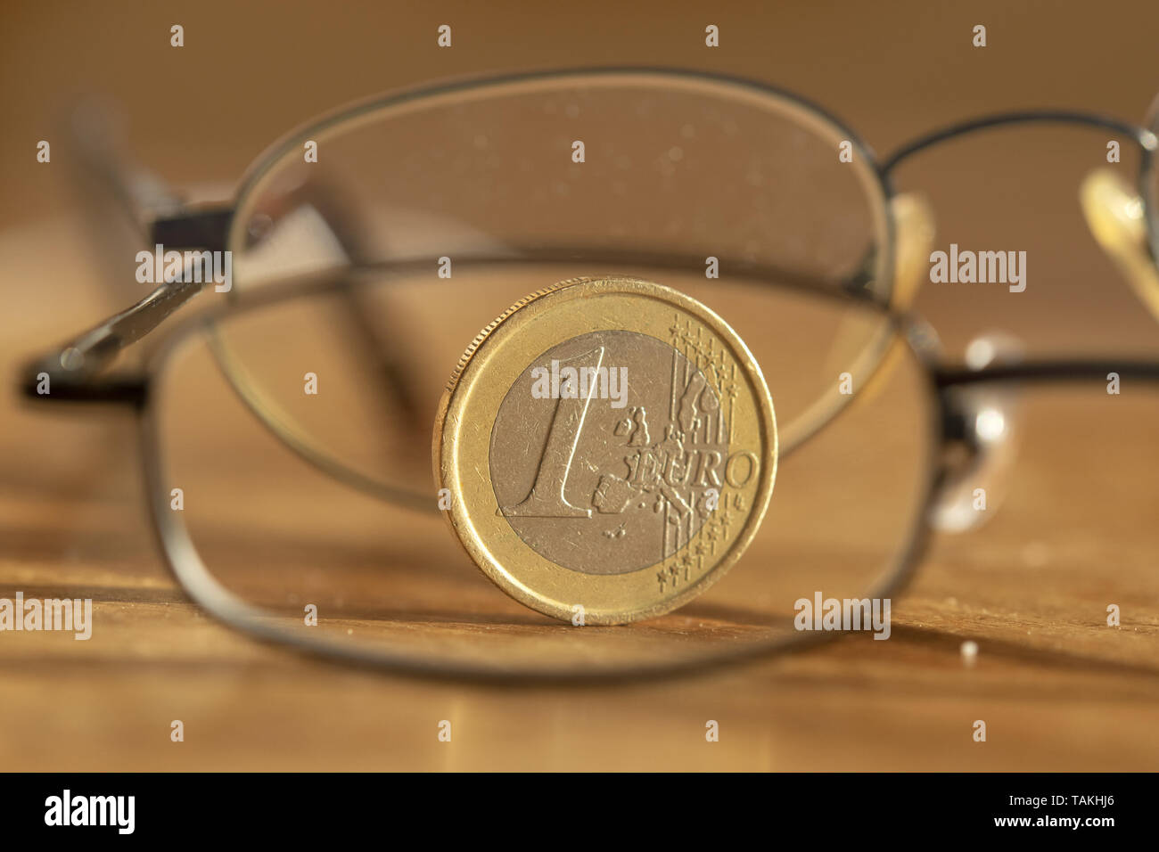 concept of shrewd savings with one euro photographed through a pair of specs Stock Photo