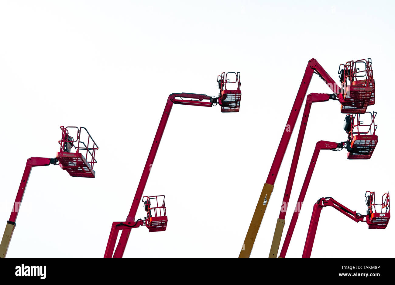 Red articulated boom lift. Aerial platform lift. Telescopic boom lift