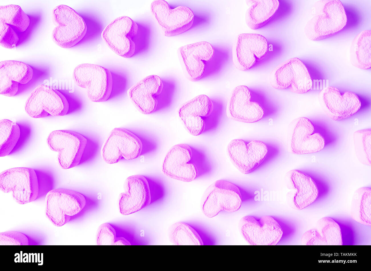 Vibrant and Pastel Purple Heart Shaped Marshmallow Candies Scattered on