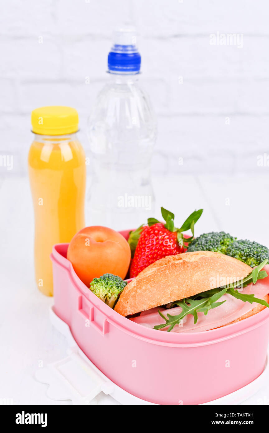 School lunch on a white wooden table and a blackboard for a lesson ...