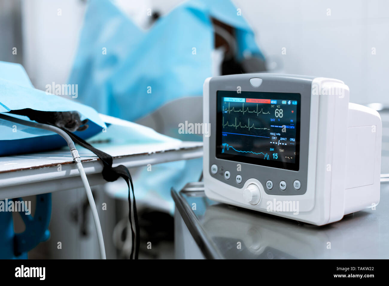 Cardiac monitor at operating table with dog on background. Pet surgery
