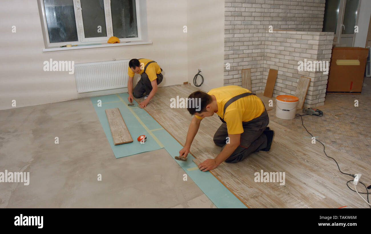 Builders Installing Laminate Floor Skilled Workers Lay Laminate