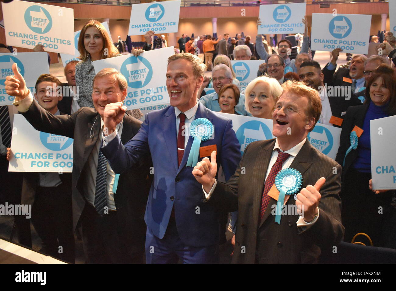 The Brexit Party's three winning candidates in the West Midlands region - Rupert Lowe, Martin Daubney and Andrew Kerr - pose for pictures alongside supporters at Birmingham's International Convention Centre. Stock Photo