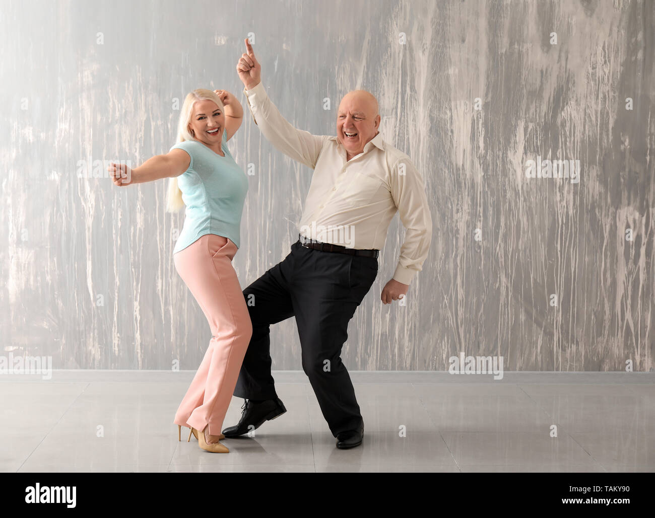 happy old couple dancing in the night life