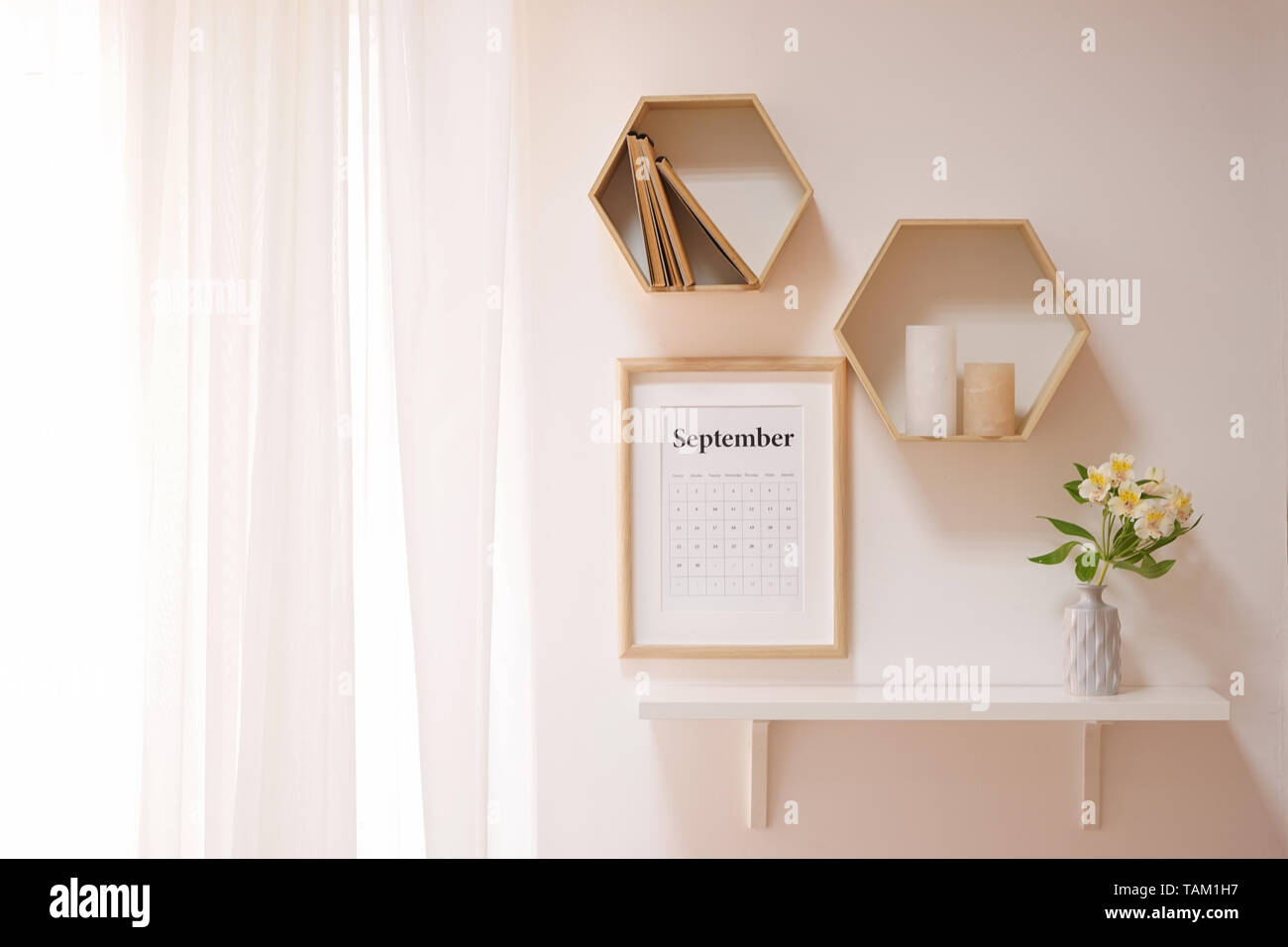 Calendar and shelves in interior of light room Stock Photo - Alamy