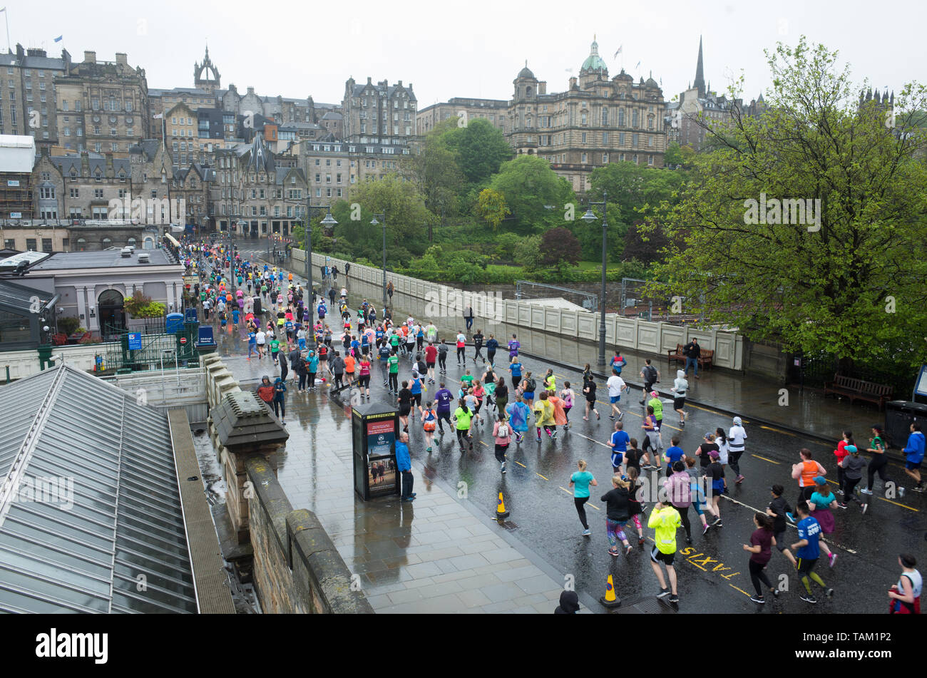 Competitors taking part in the 2019 Edinburgh Marathon Festival half marathon run through Princes Street Gardens in the rain. Stock Photo