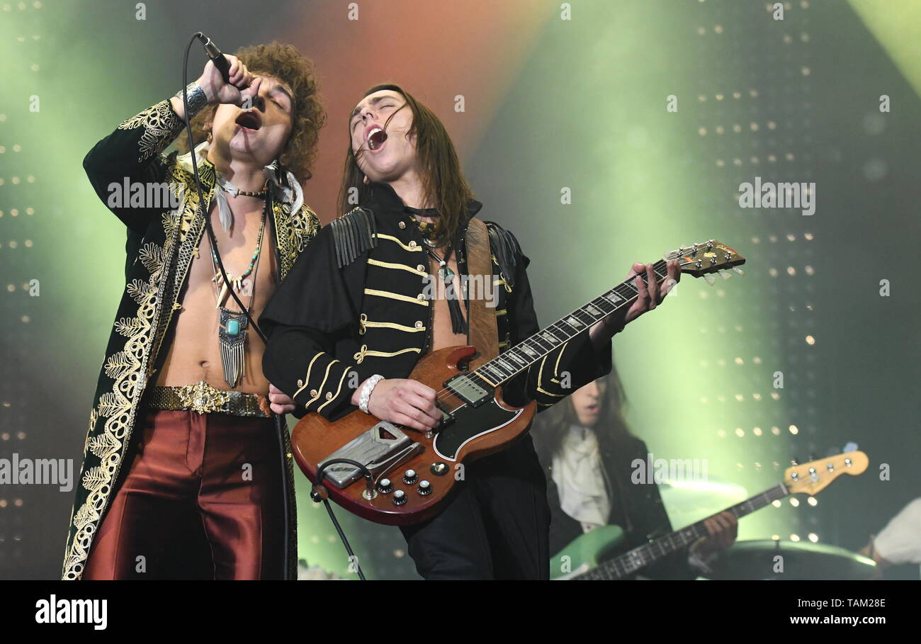 Brothers Josh and Jake Kiszka are shown performing together on stage ...