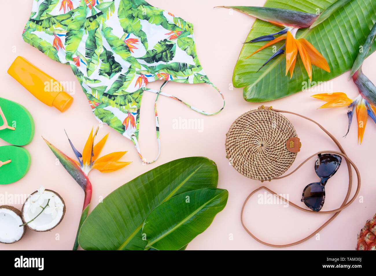 Summer flat lay scenery with beach accessories and tropical leaves and ...