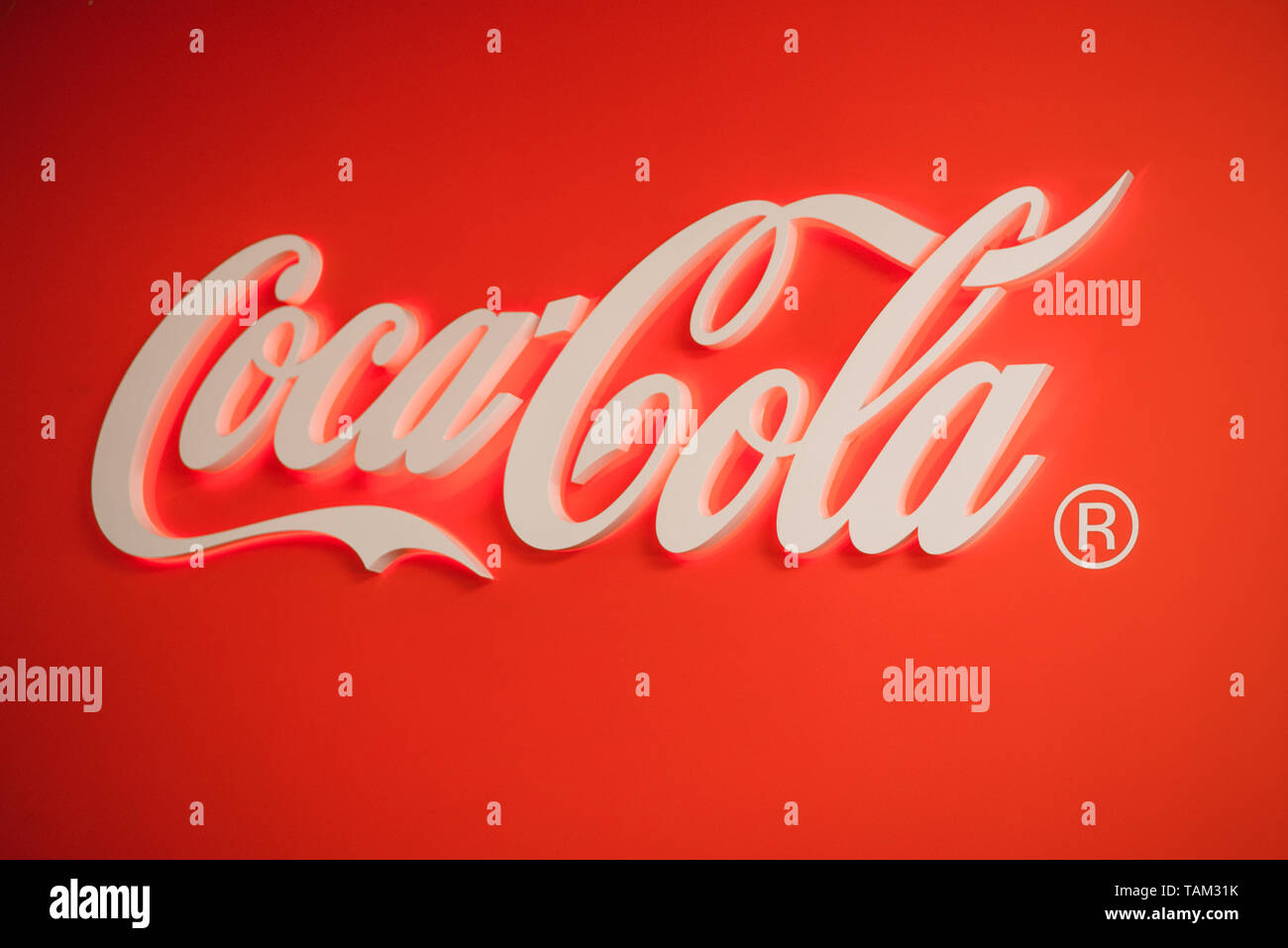 Samara Russia- 04.30.2019: Glowing Coca Cola logo. Coca Cola stamp on a red background. Stock Photo