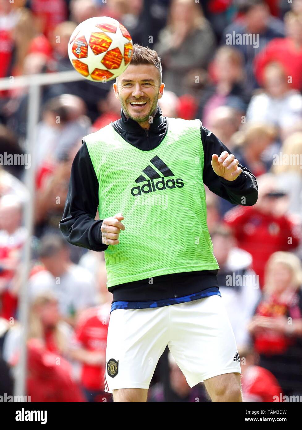 Manchester United Legends David Beckham warms up before the legends match at Old Trafford, Manchester. Stock Photo
