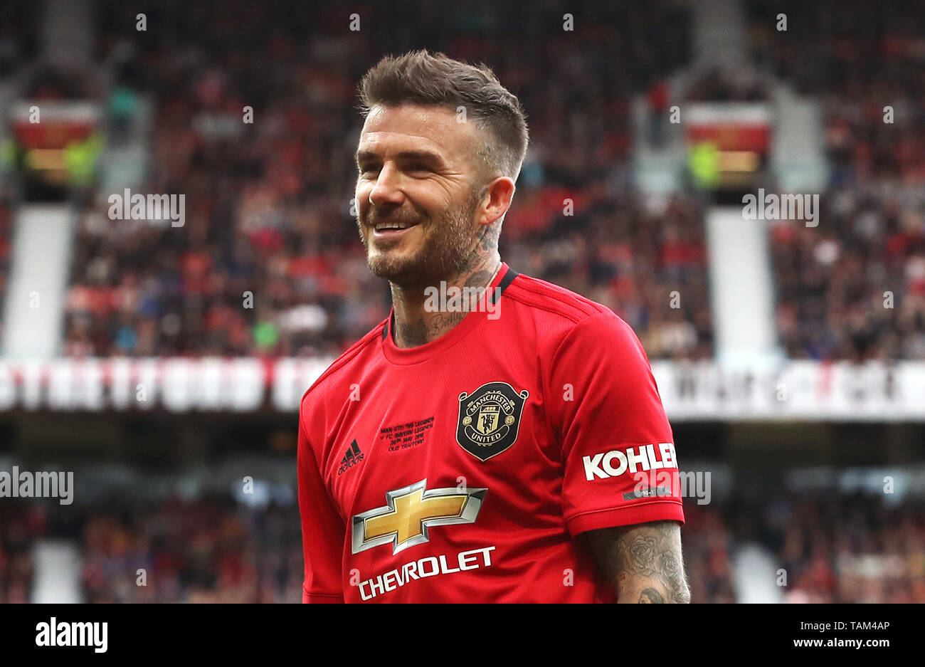 Manchester United Legends David Beckham reacts during the legends match at Old Trafford, Manchester. Stock Photo