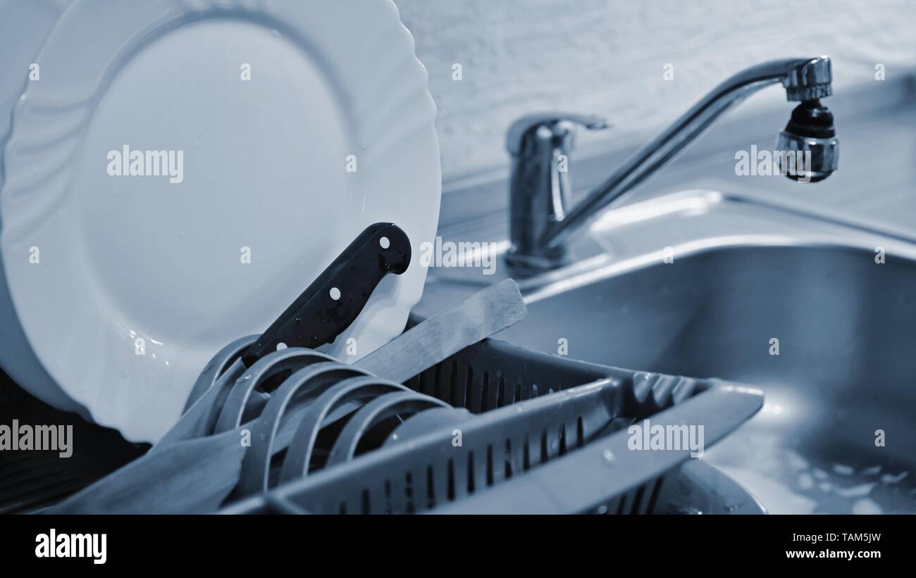 Dishes in drip tray. Clean washed dishes in the kitchen Stock Photo Alamy