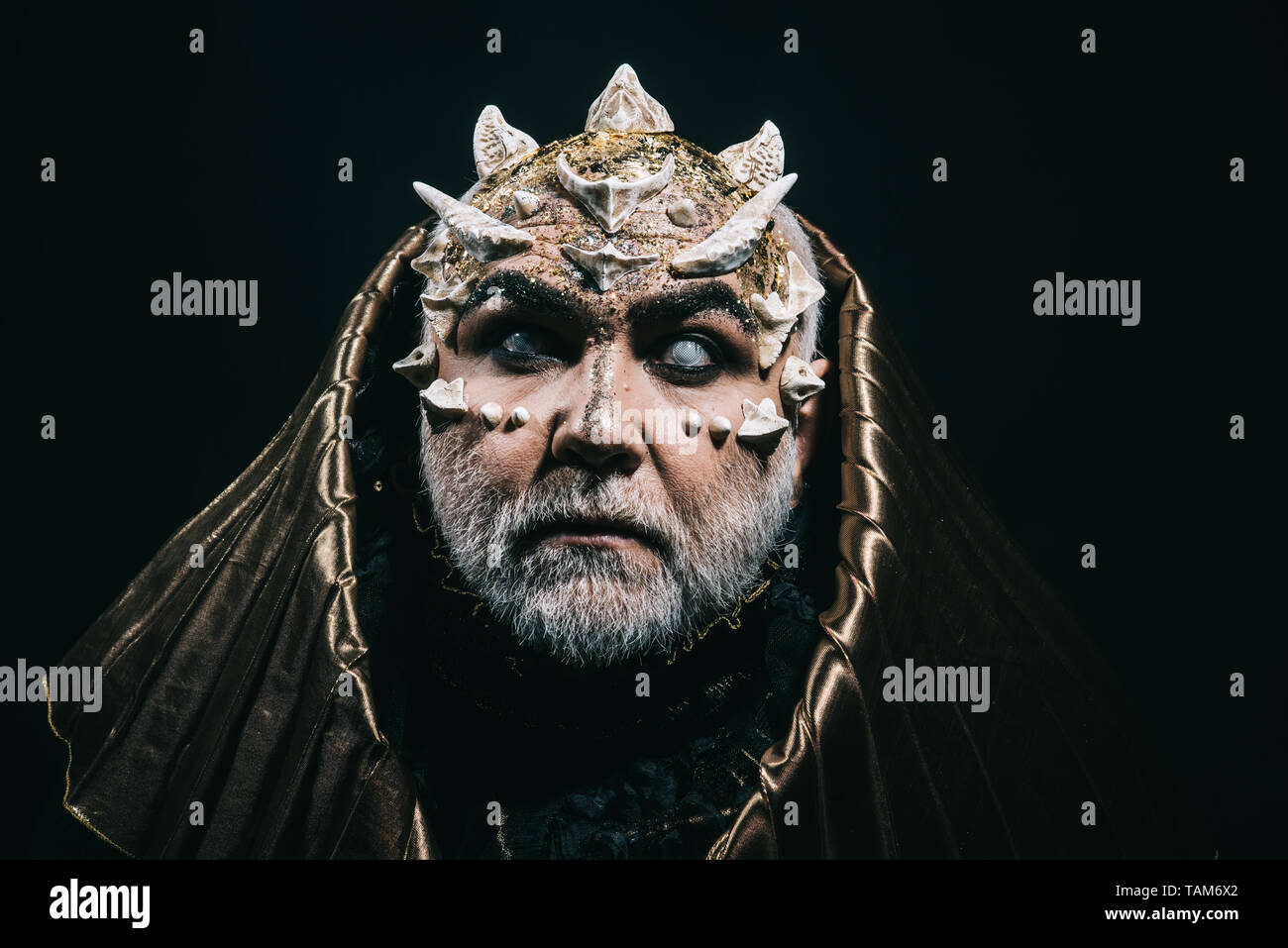 Blind ancient monster with thorns on myth and legends concept. Old guardian of forest deity with white beard and horns on black Stock Photo - Alamy
