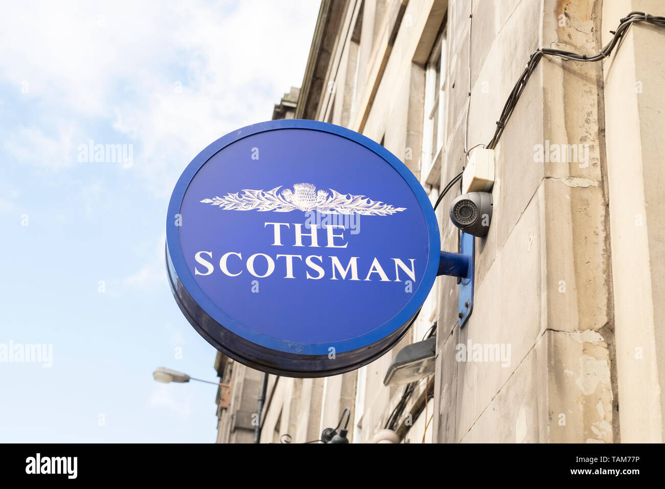 The Scotsman newspaper name sign on wall outside newsagent, Edinburgh